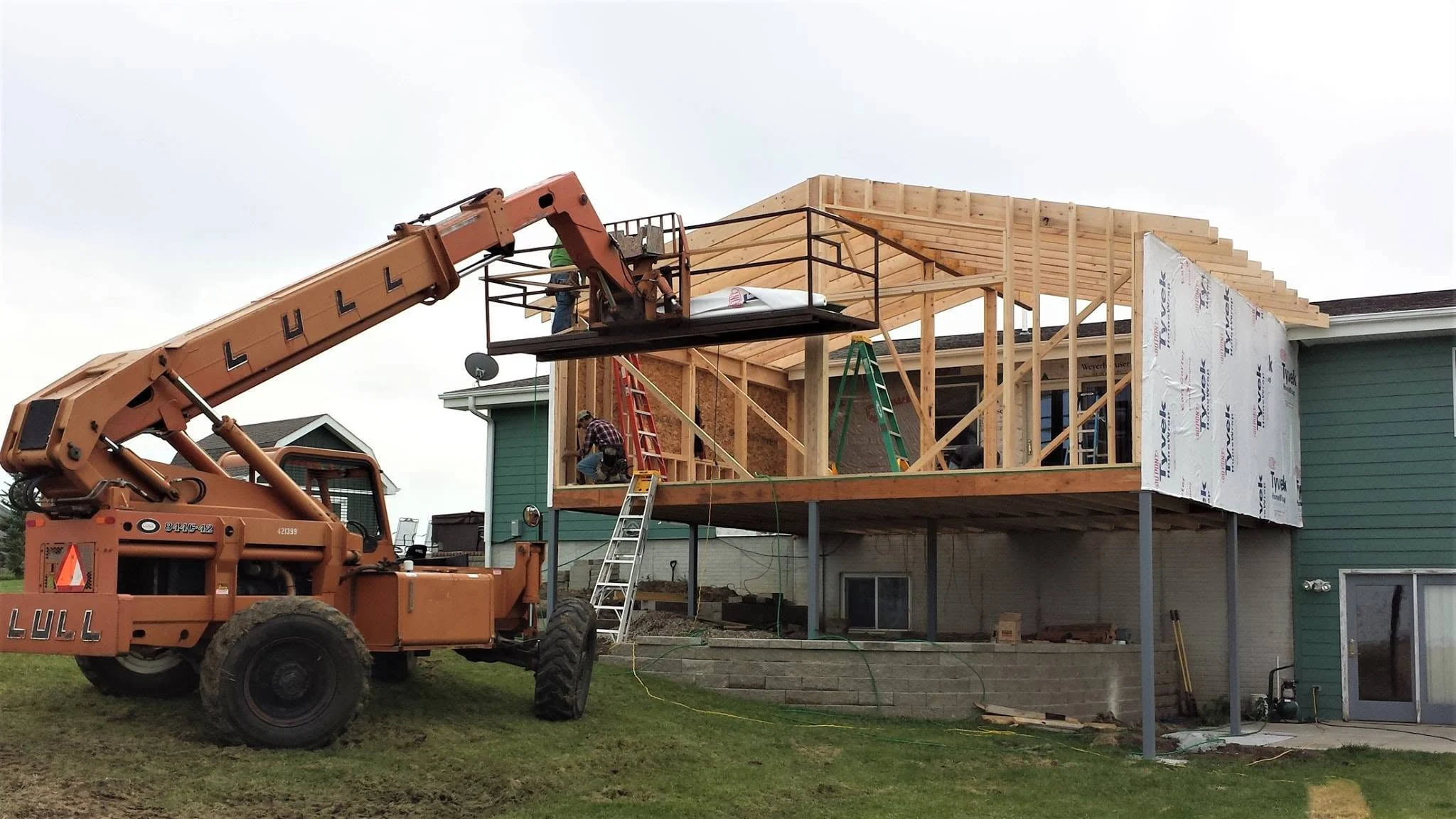 Great room addition being framed at the back of an acreage home