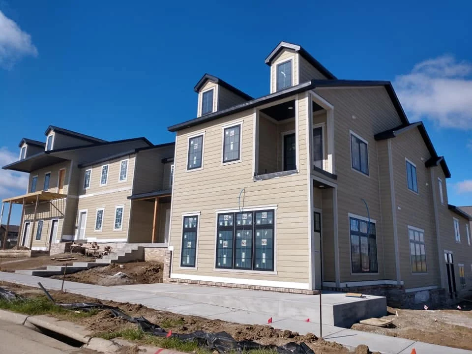 Three-story live/work buildings with dormers nearing completion