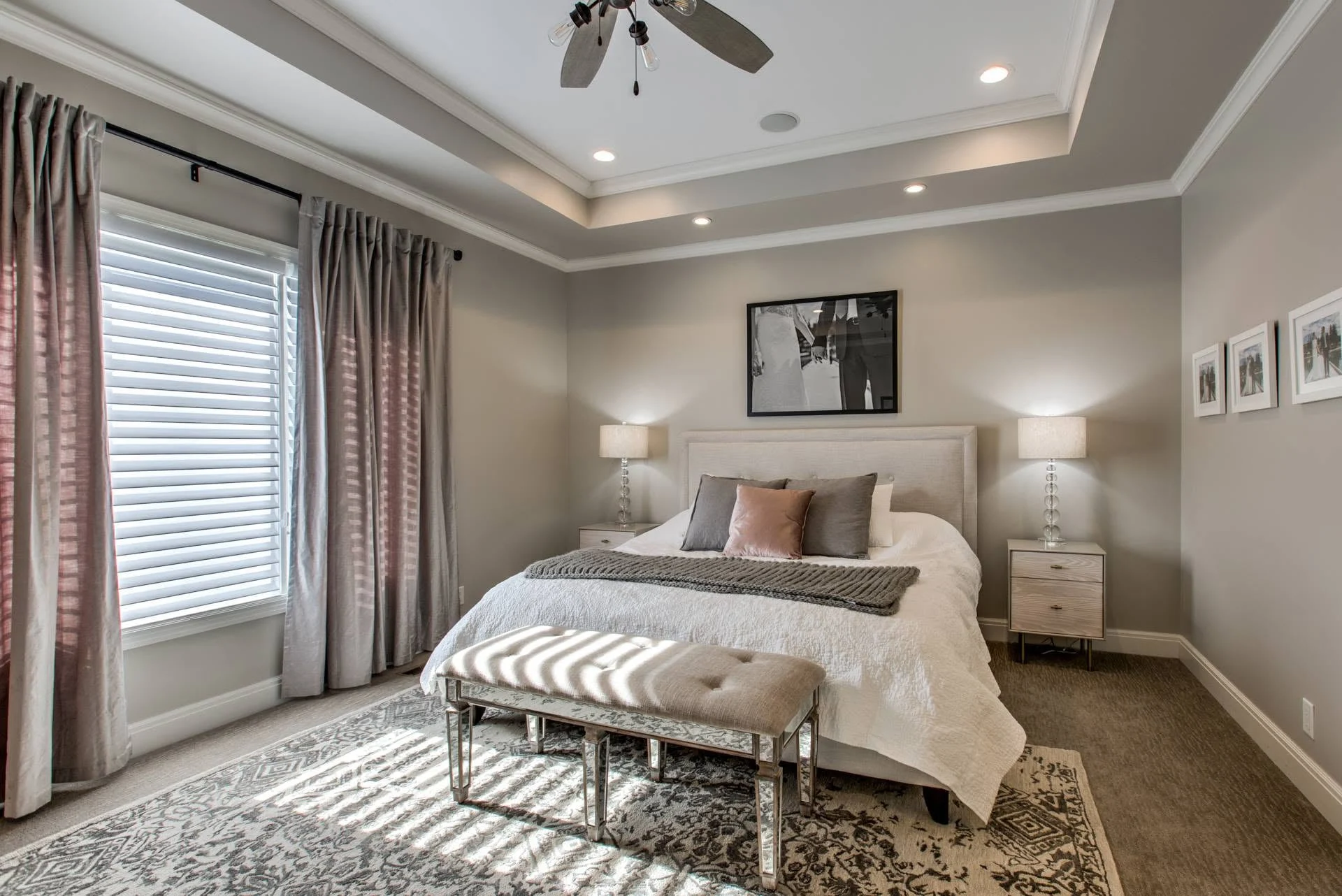 Bedroom with a tray ceiling, crown molding, and a ceiling fan